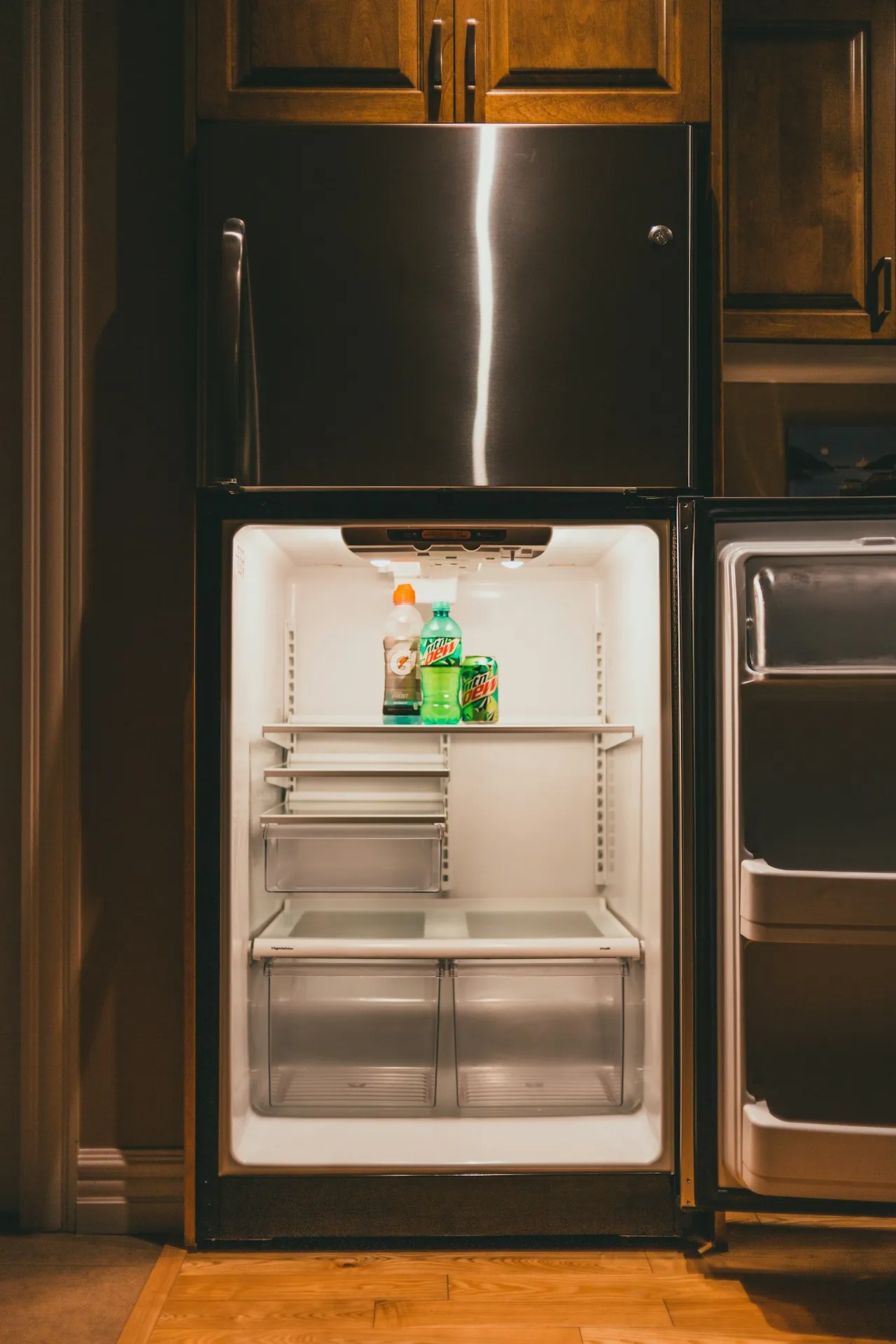 Open refrigerator cabinet showing the interior drain line.